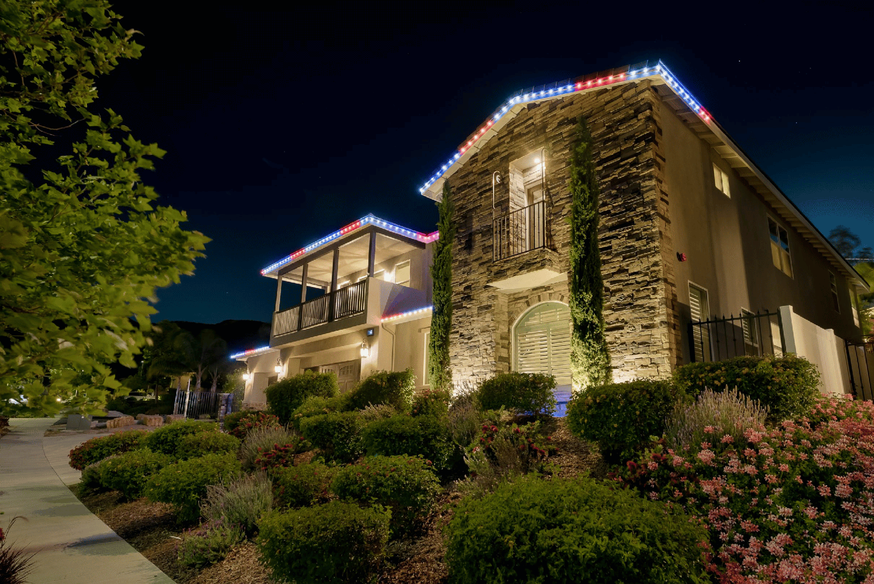 Home with permanent LED roofline lighting on at night